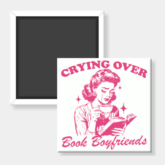 Fridge magnet with a design of a woman reading a book and text 'Crying Over Book Boyfriends' on a white background.