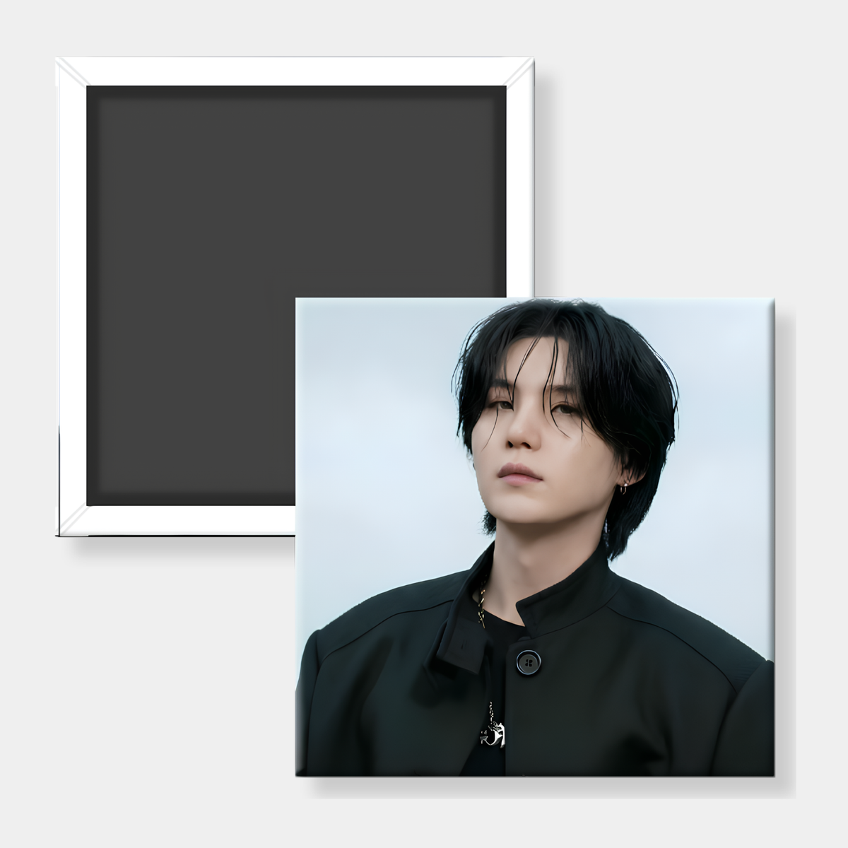 A square photo magnet or printed magnet shown from both sides on a light gray background. The front side shows a portrait of a person with dark hair wearing a black top against a pale blue-gray background.