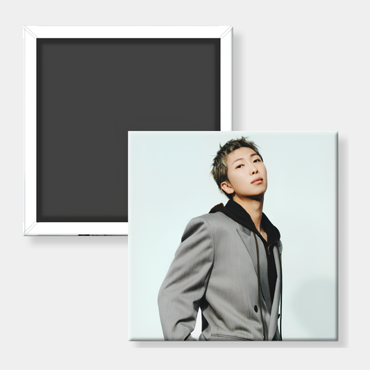 A square custom photo magnet showing a portrait of a man in a gray blazer, displayed alongside the back of another magnet with a white frame and dark magnetic surface on a light gray background.
