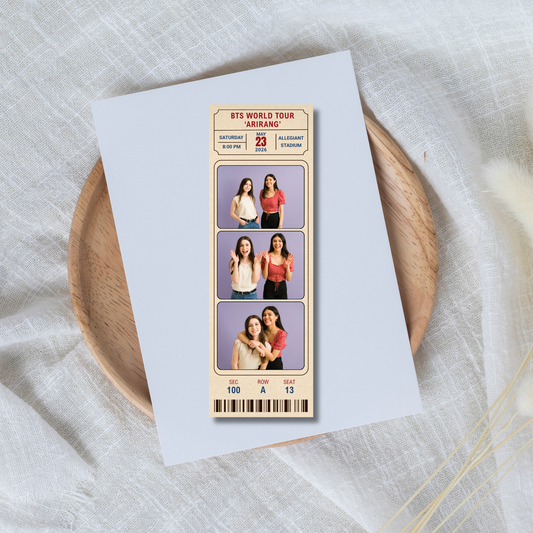 Memorabilia ticket with images of people on a white card, placed on a wooden plate.