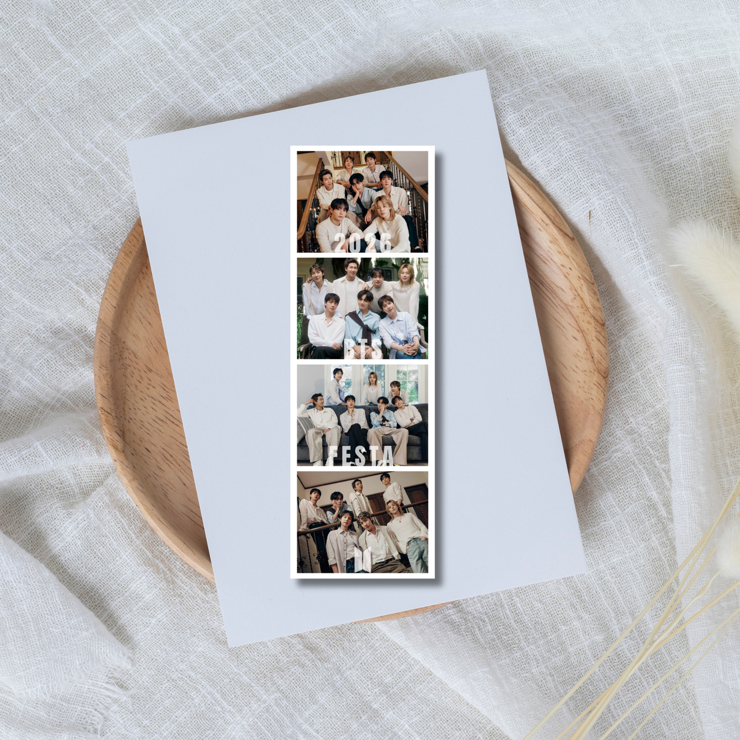 Collage of BTS family photos on a white card with a wooden plate underneath