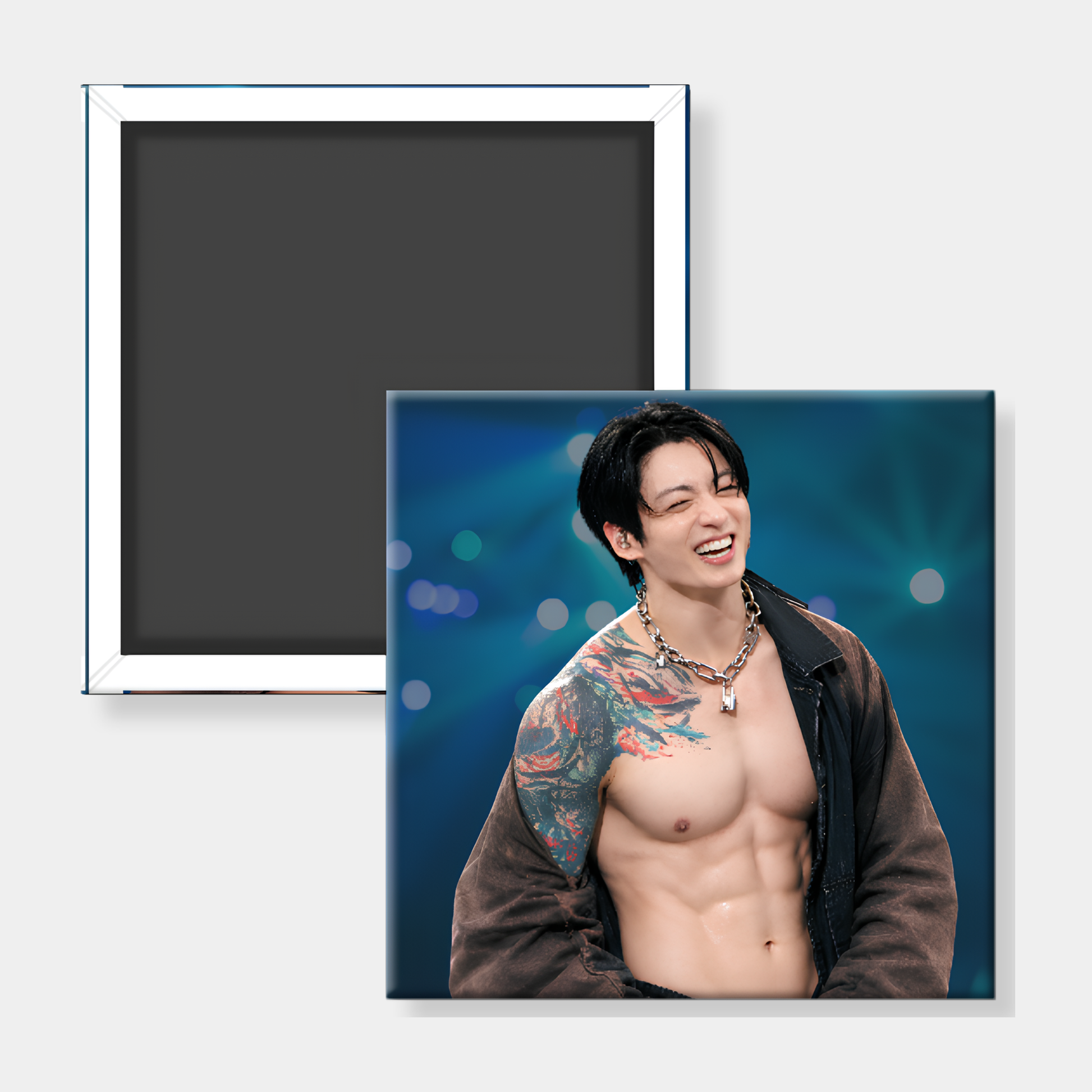 A square photo magnet featuring a smiling shirtless man with tattoos on a blue stage-like background, shown alongside the back of a matching magnet on a light gray background.