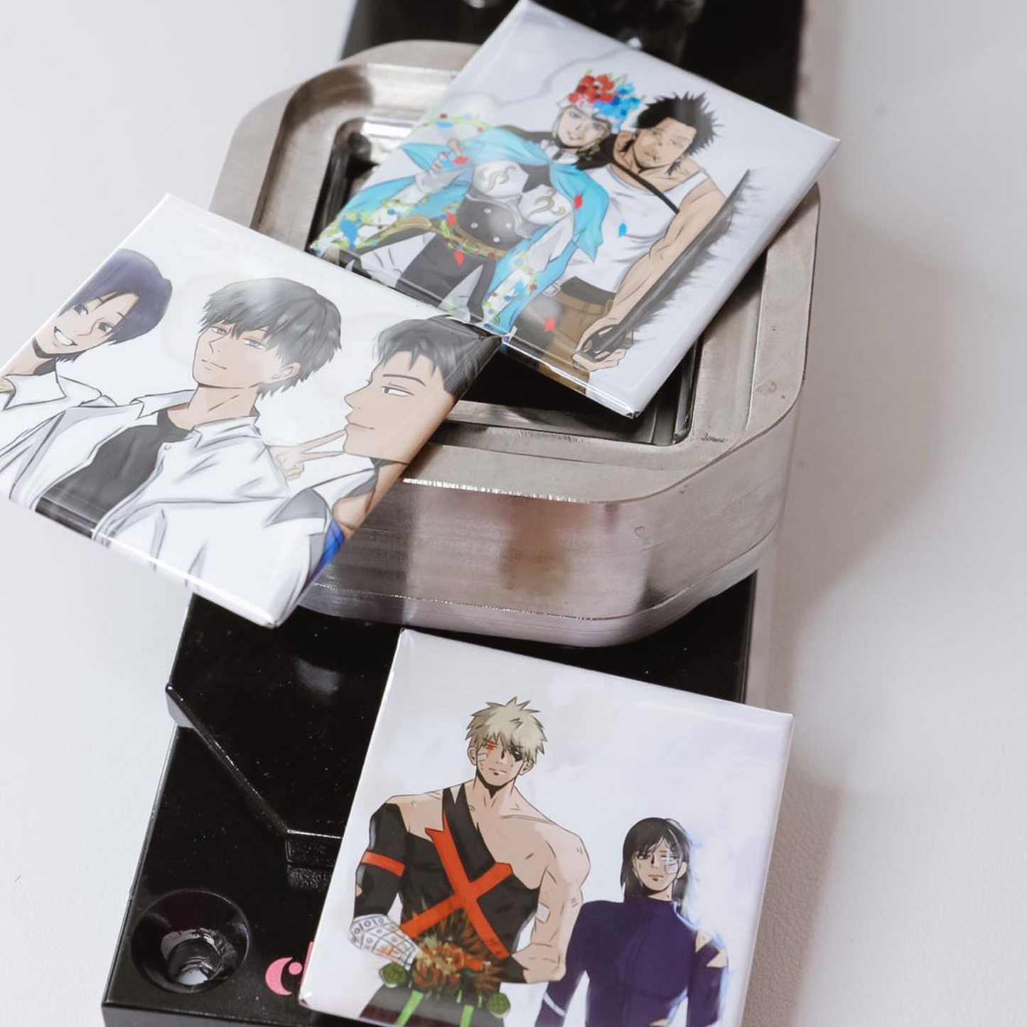 Set of anime square magnets with character illustrations on a metal stand.
