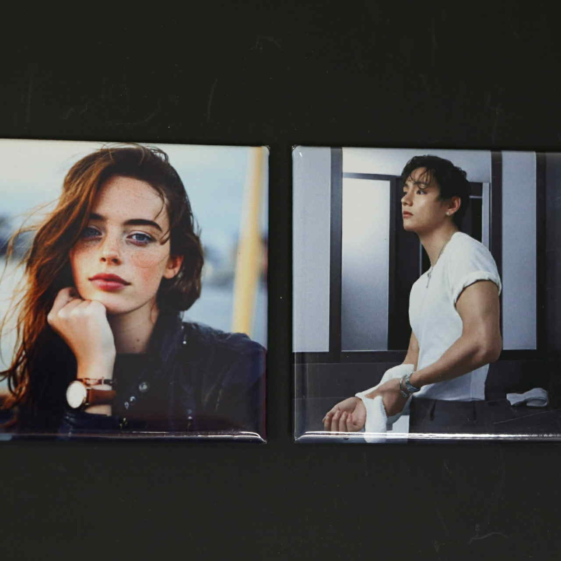 Two square photo magnets of a woman and a man on a dark background