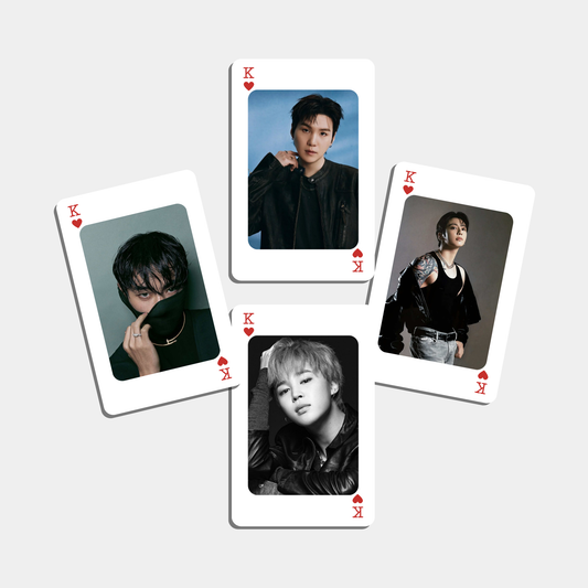 Playing cards with portraits of a person on each card on a light gray background