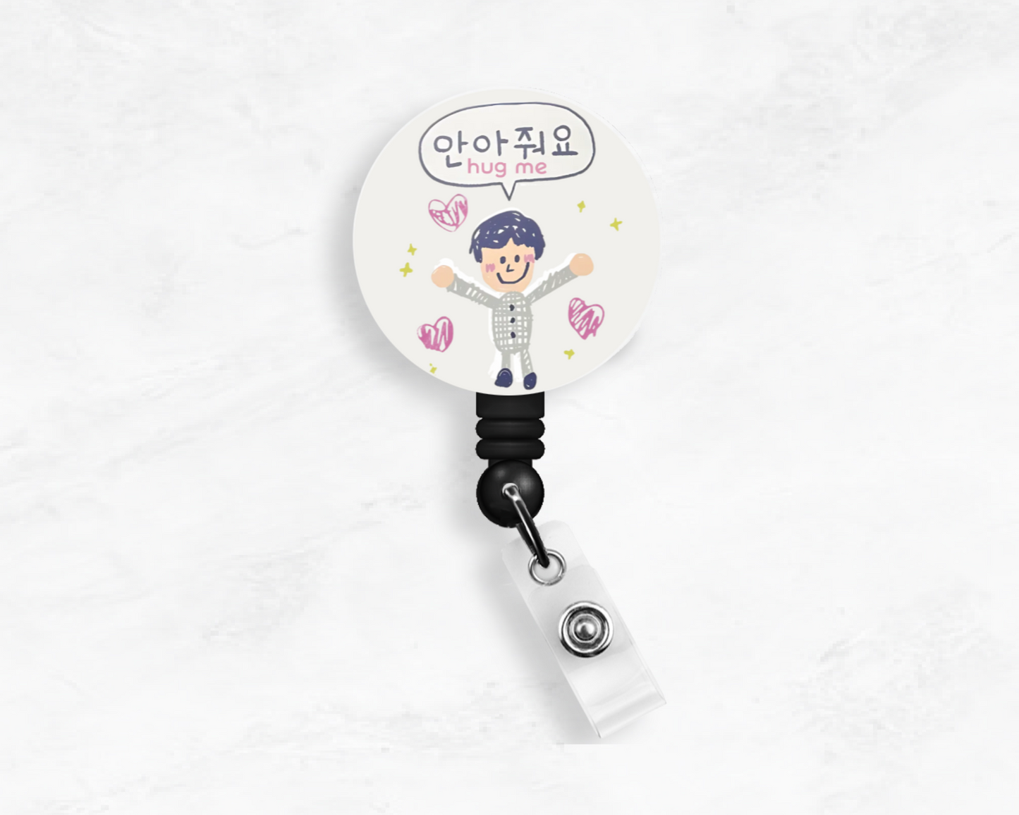 A badge reel with a drawing of a character. It includes an alligator-style metal clip and a cord.